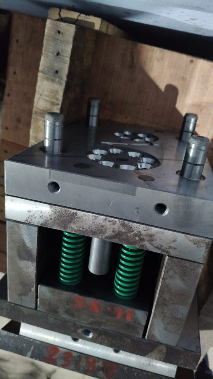 Close-up of a precision injection mold with ejector springs